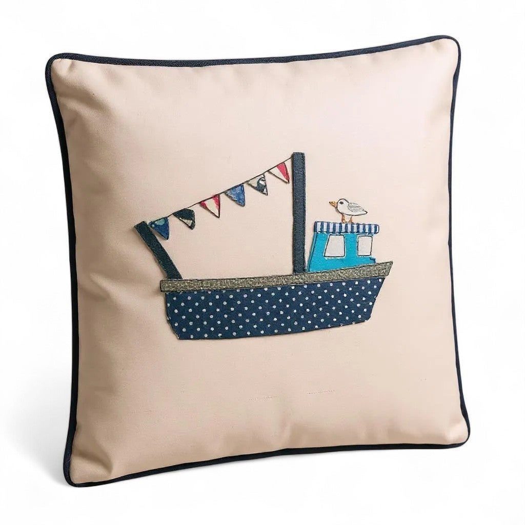 Handcrafted embroidered boat cushion with nautical appliqué design.