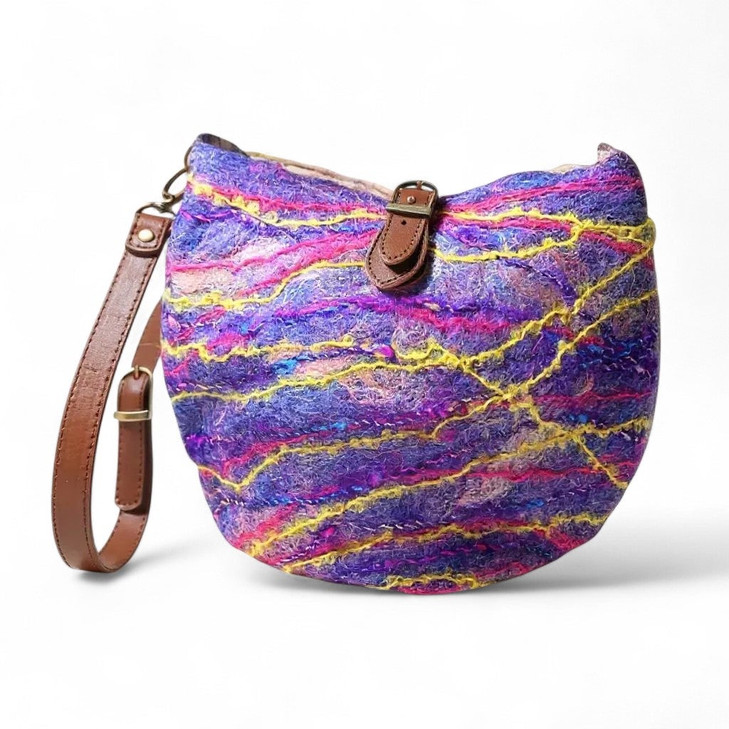 Handcrafted felted shoulder bag with colorful wool and leather strap.