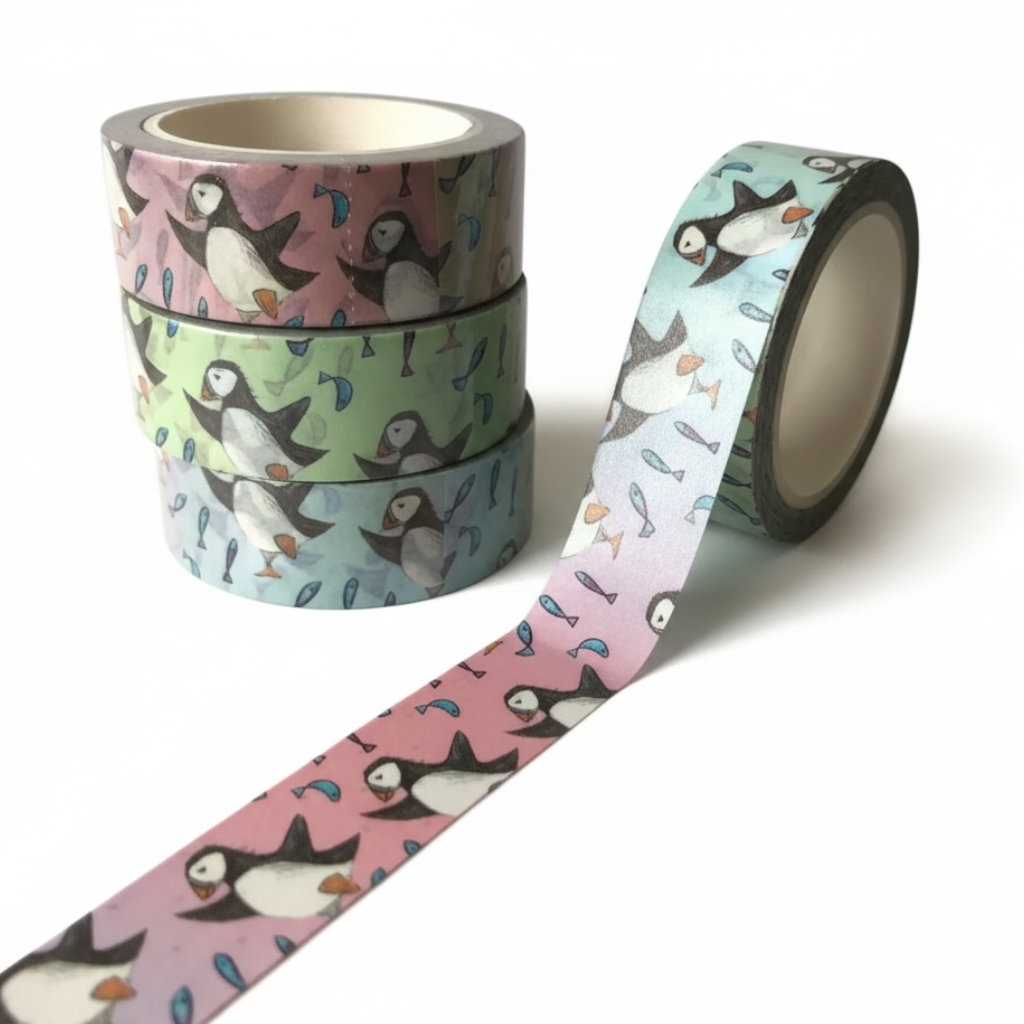 Puffin washi tape with a repeating pattern of puffins and fish in soft colors.