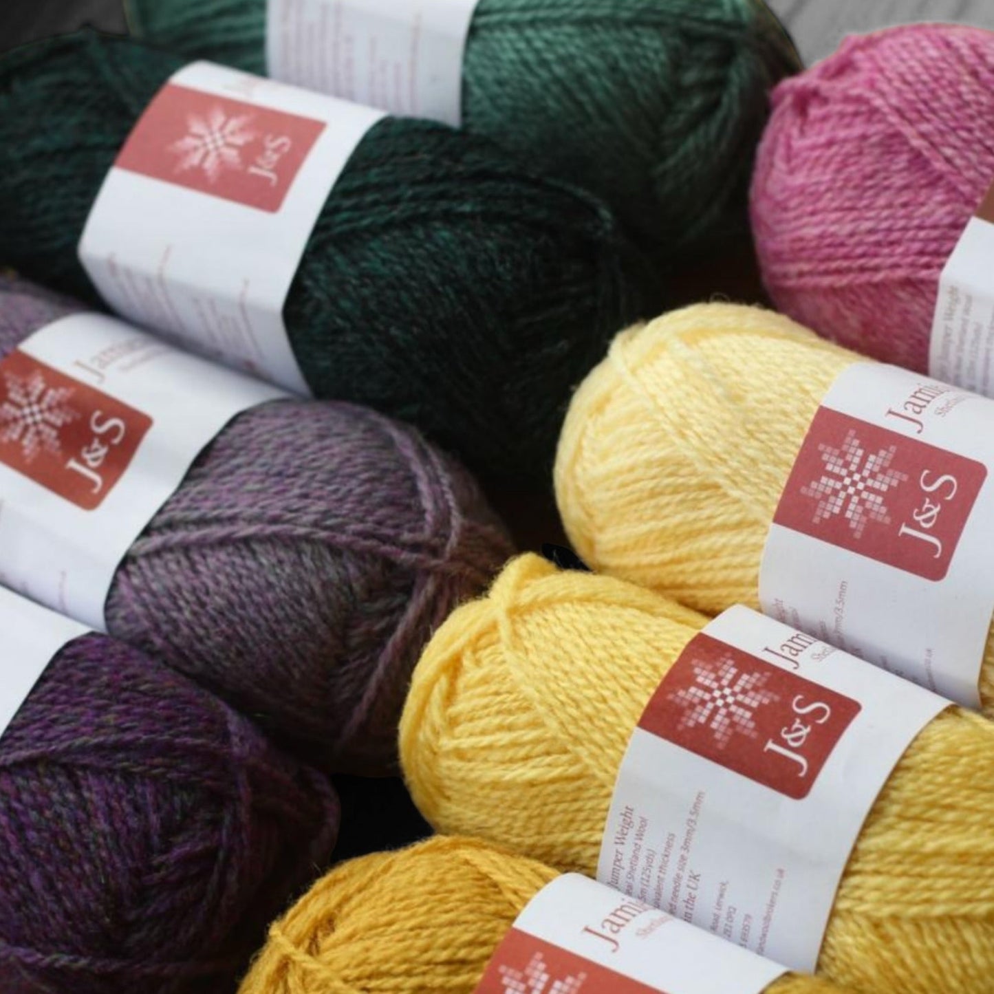 Shetland wool yarn in various colors including green, purple, pink, and yellow.
