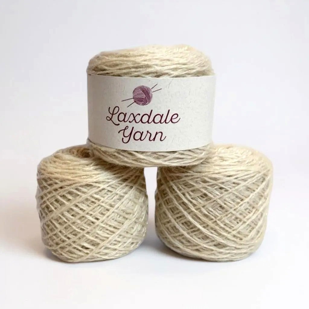 Three spools of Laxdale Yarn in natural white wool.