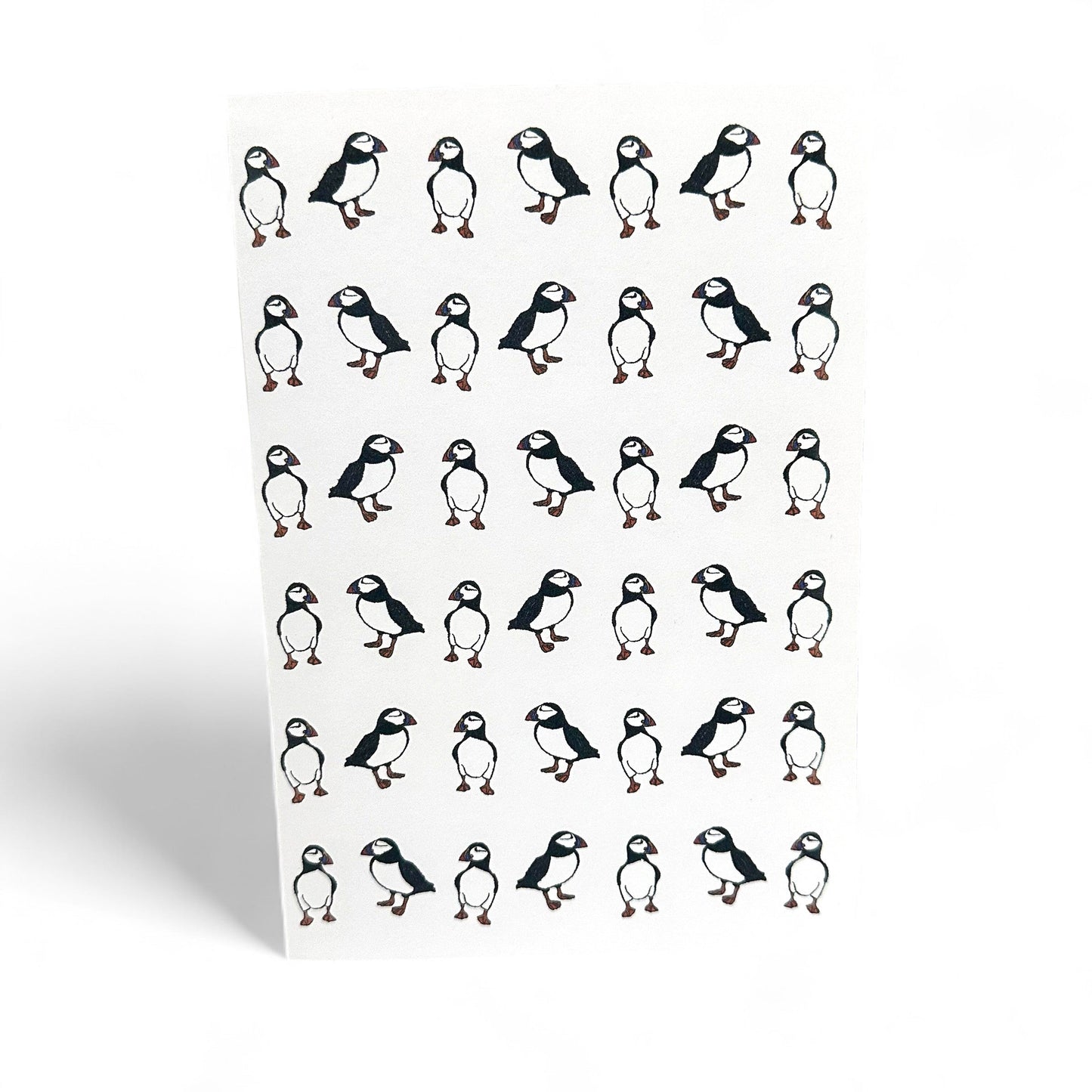 Printed card featuring multiple illustrations of puffins.