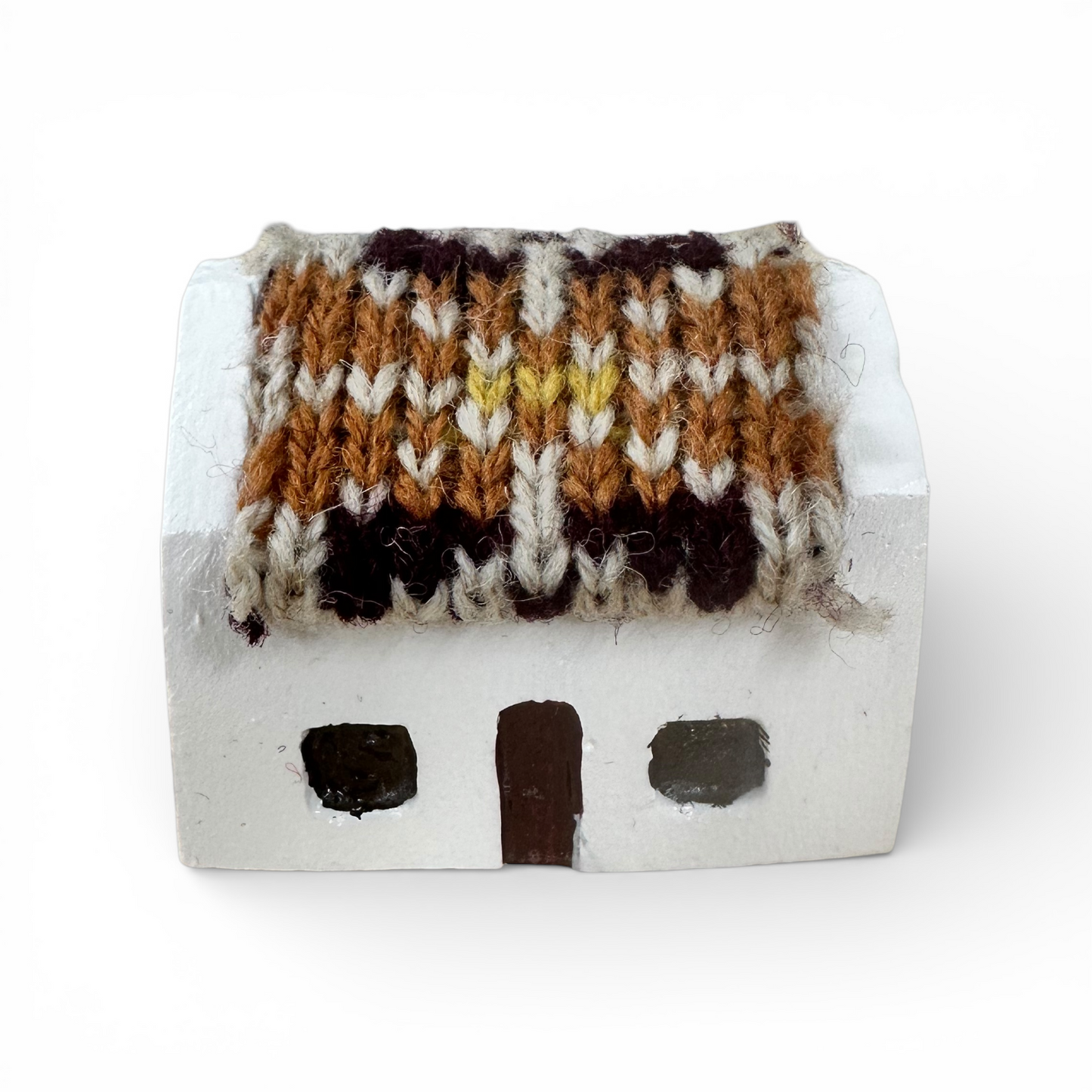 Handmade white miniature croft house with a brown and white knitted wool roof.