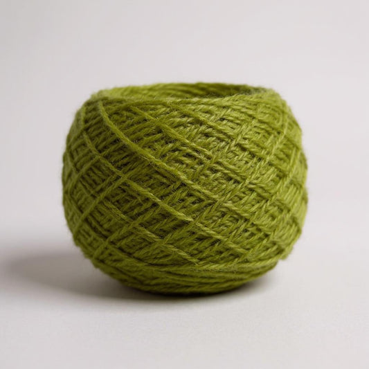 A ball of moss-green Shetland wool.