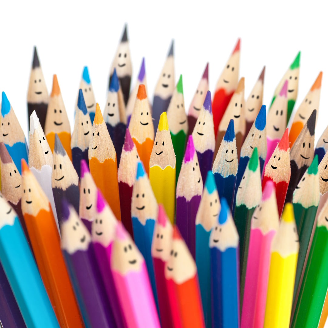 Colorful pencils with smiling faces arranged in a pattern on a white background