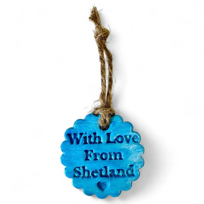 Blue scalloped clay ornament with "With Love From Shetland" text.