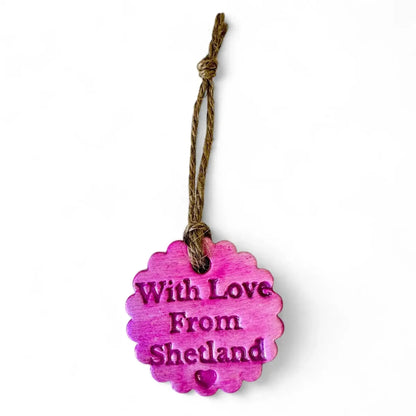 A pink scalloped ornament with "With Love From Shetland" and a heart.