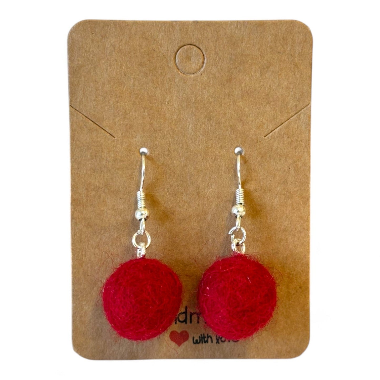 Hand felted red ball earrings on a brown card.