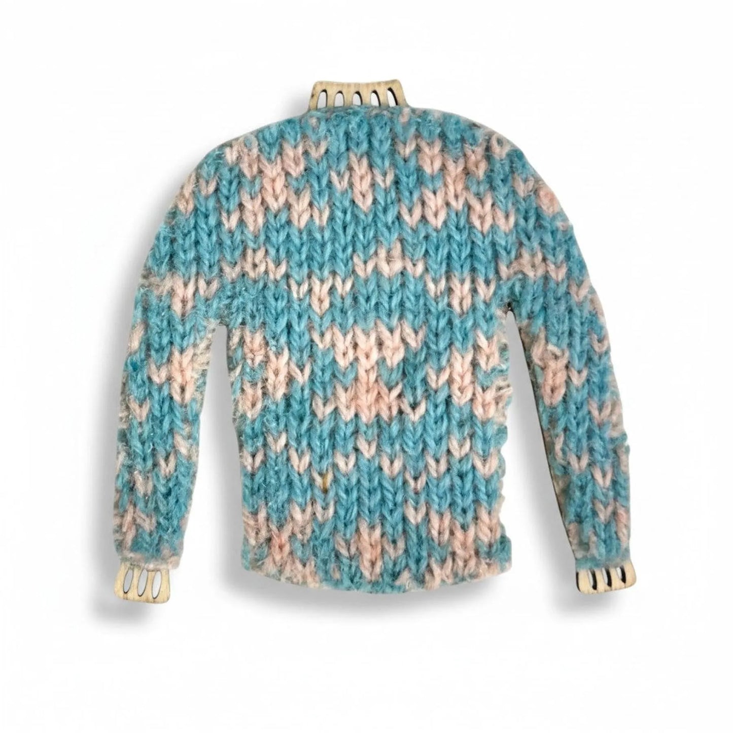 Handmade miniature knitted jumper magnet in a blue and pink textured wool pattern.