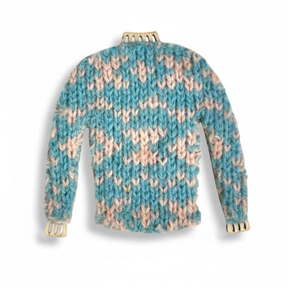 Handmade knitted jumper magnet with blue and pink yarn.