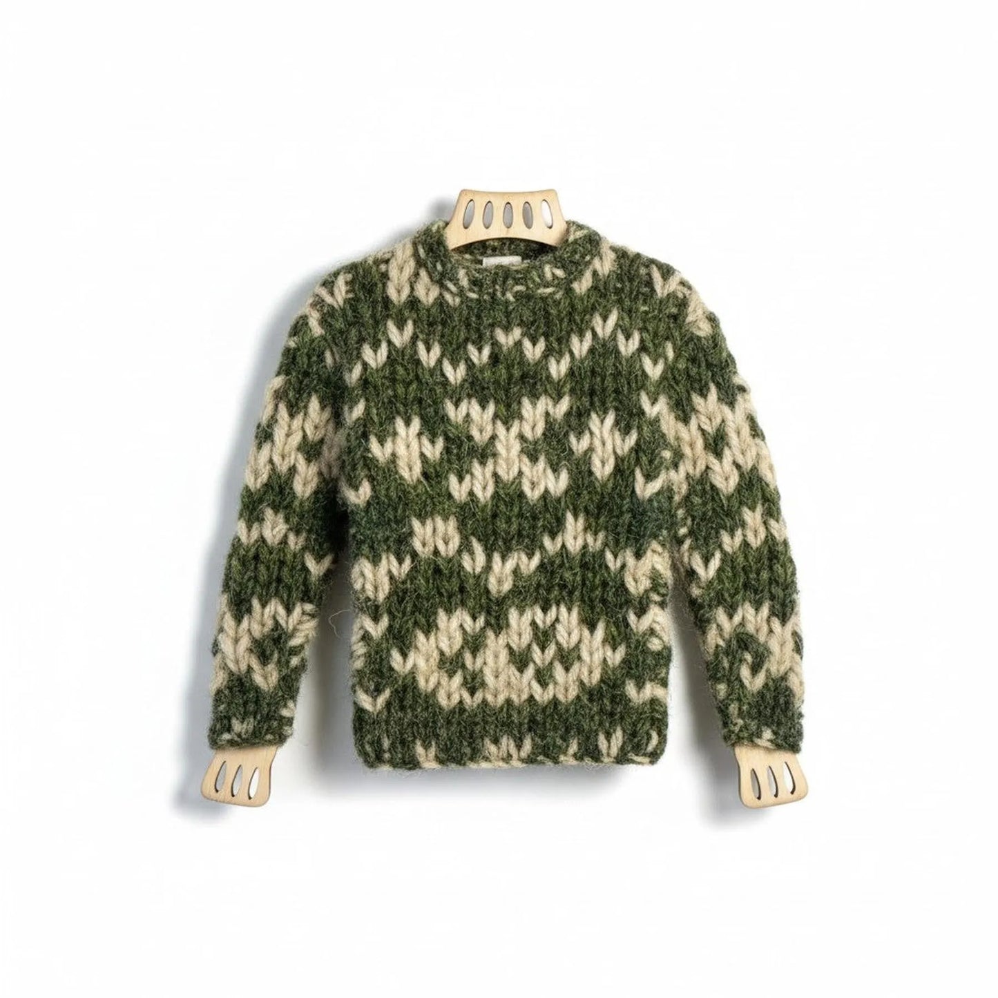 Handmade miniature knitted jumper magnet in green and cream wool on a wooden frame.