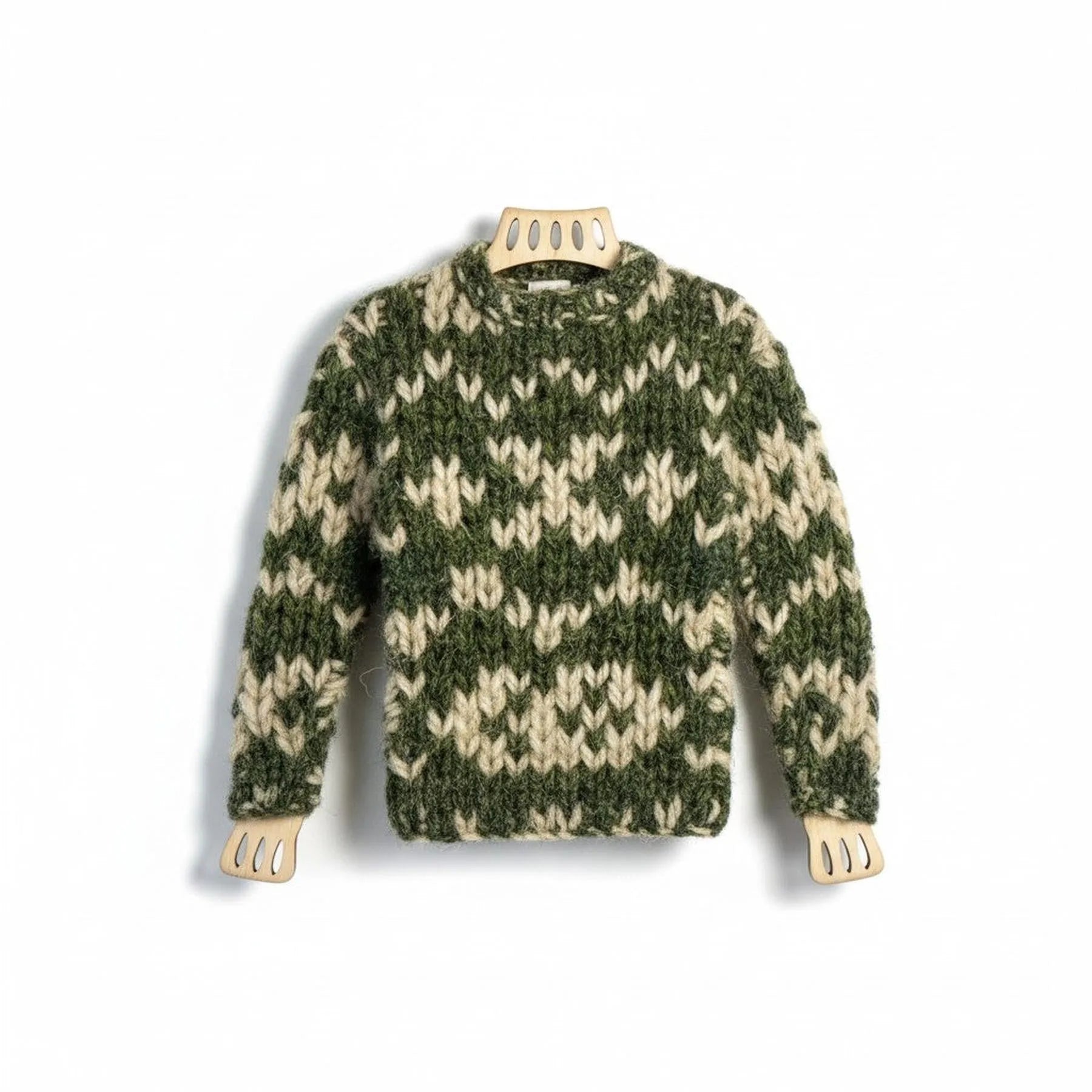 Handmade miniature knitted jumper magnet in green and cream wool on a wooden frame.