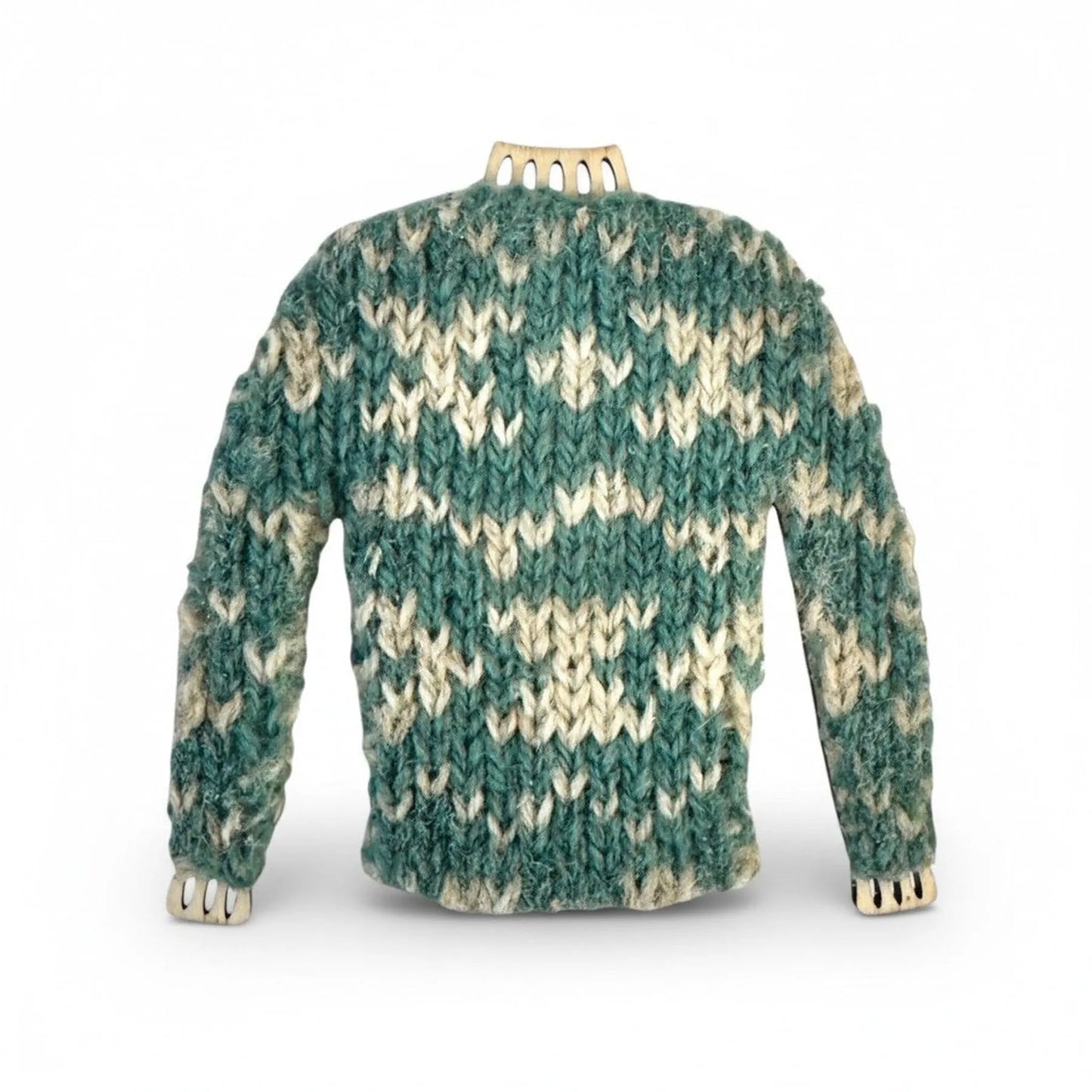 Handmade miniature knitted jumper magnet in teal and white wool on a wooden frame.