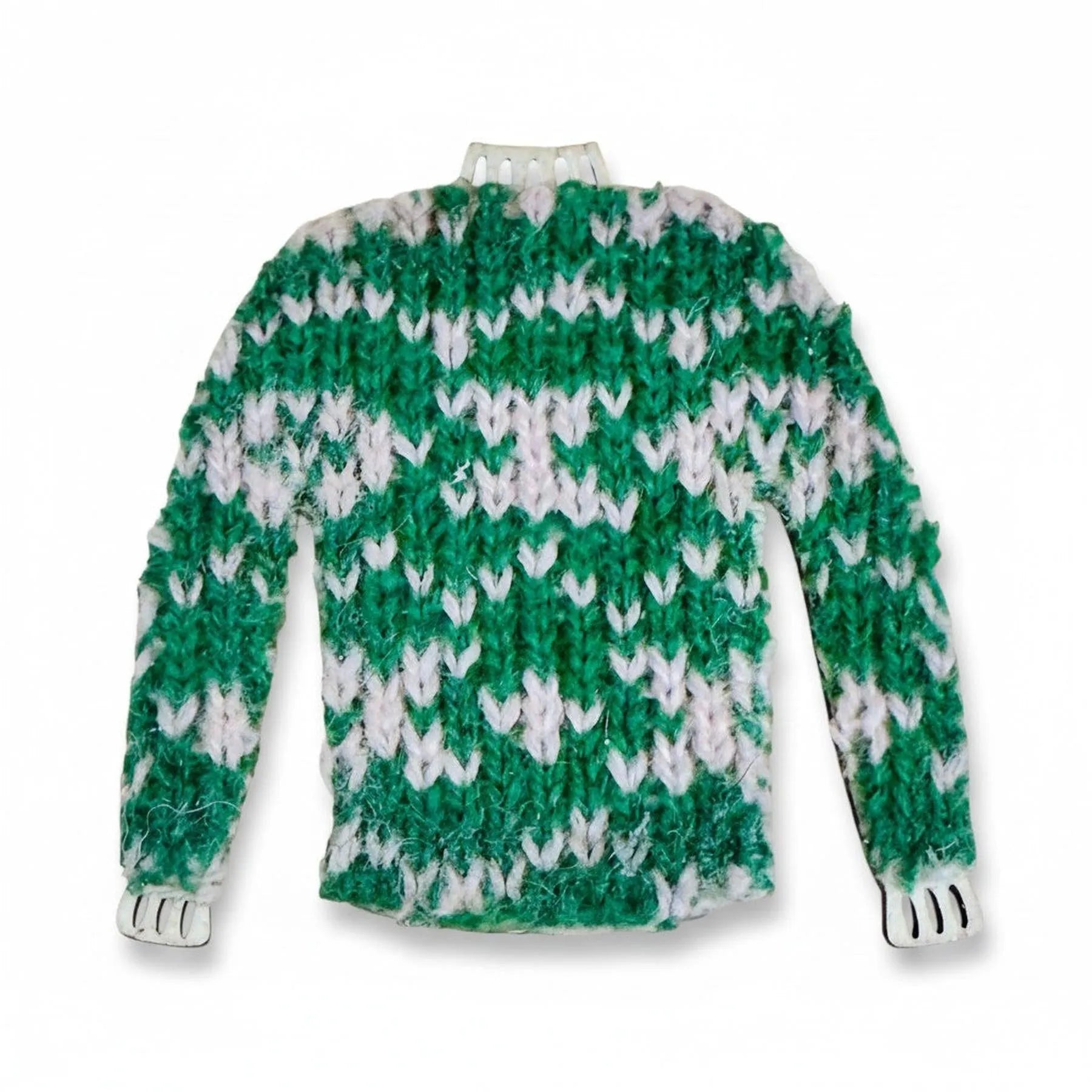 Handmade miniature green and white knitted jumper magnet with a traditional Shetland pattern.