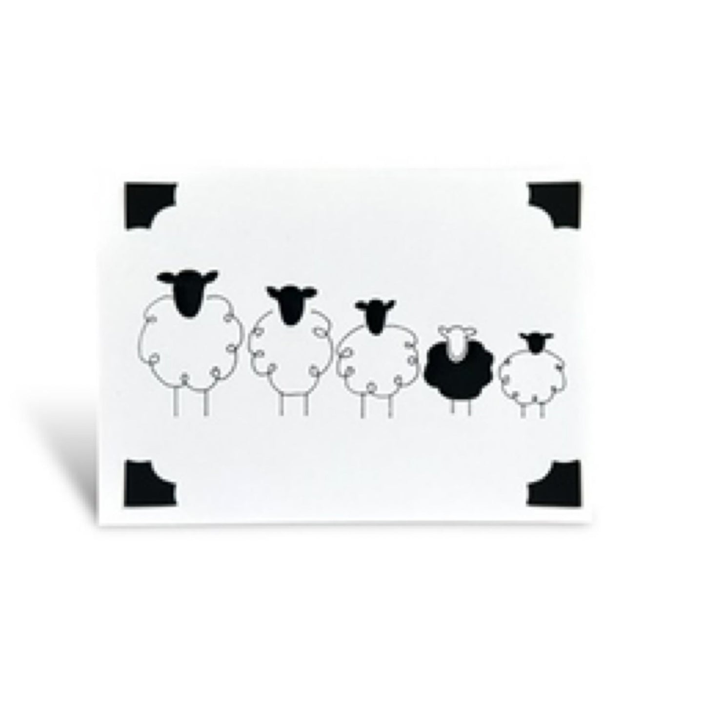Handmade card featuring a line of sheep, one of which is black.