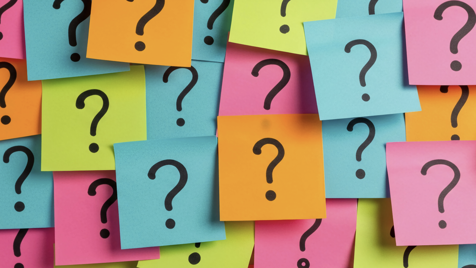 Colorful sticky notes with question marks on a multicolored background