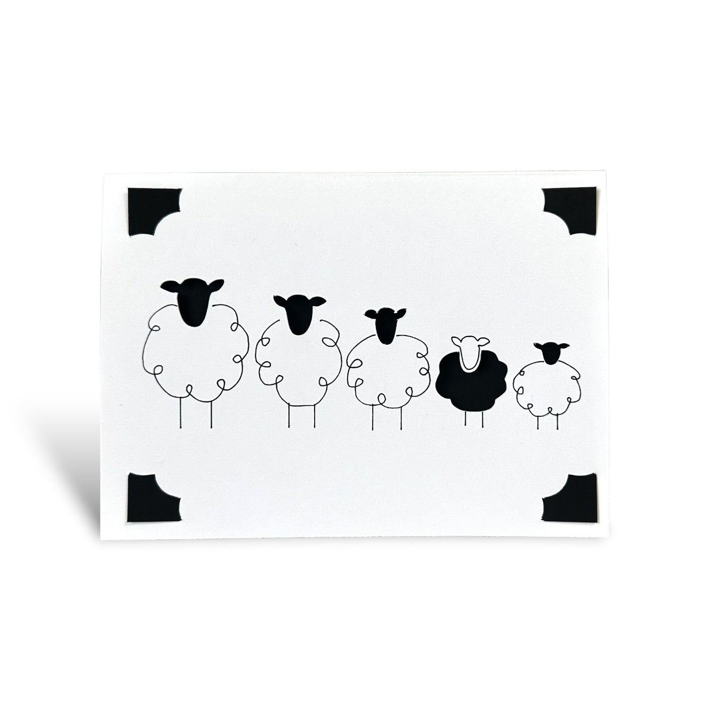 Handmade greeting card featuring a row of five minimalist black and white Shetland sheep.