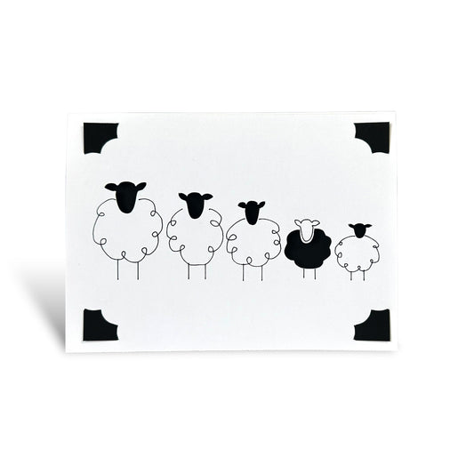 Handmade greeting card featuring a row of five minimalist black and white Shetland sheep.