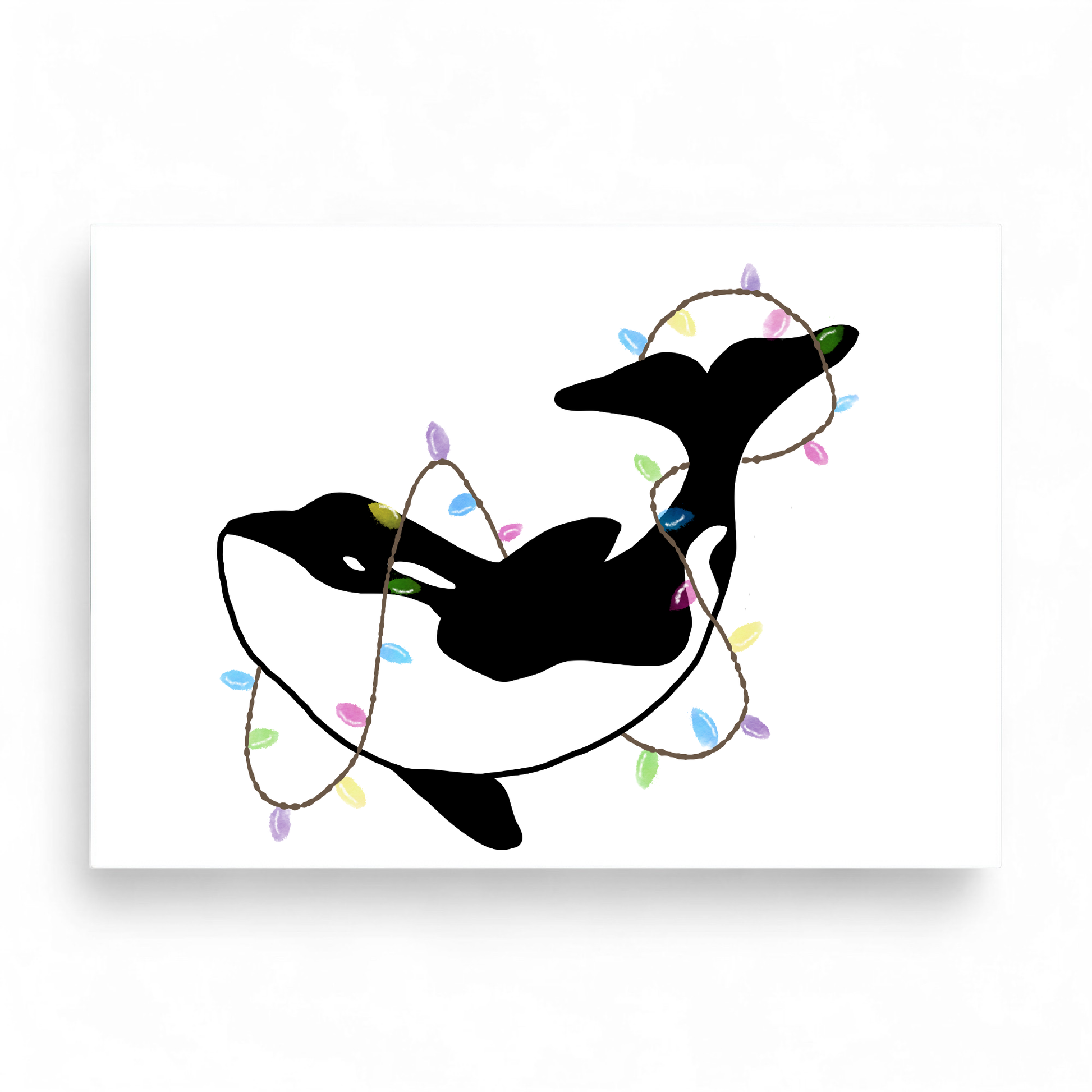 Printed Christmas card featuring a black and white orca wrapped in colorful festive lights.