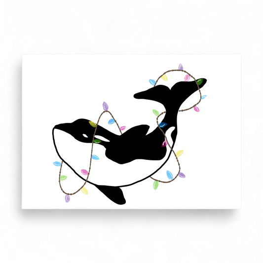 Printed Christmas card featuring a black and white orca wrapped in colorful festive lights.