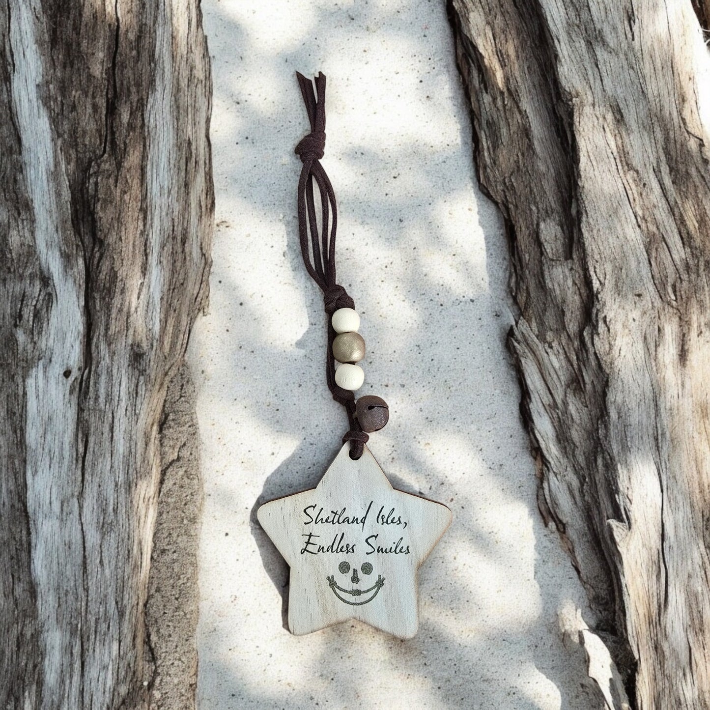 Wooden star ornament with "Shetland Isles, Endless Smiles" text and a smiley face.