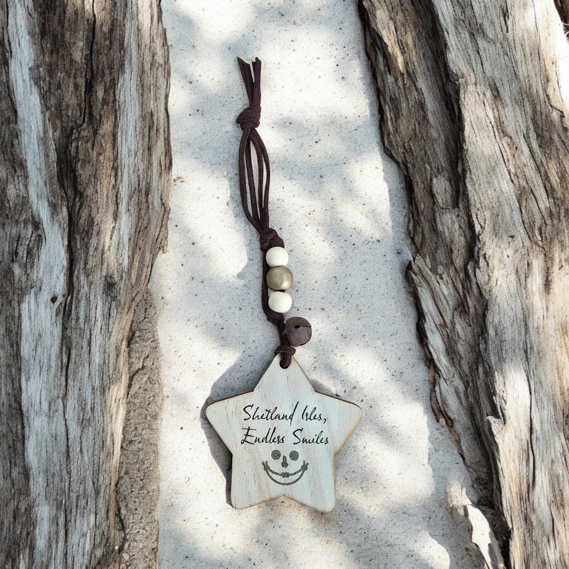 Wooden star ornament with "Shetland Isles, Endless Smiles" text and a smiley face.