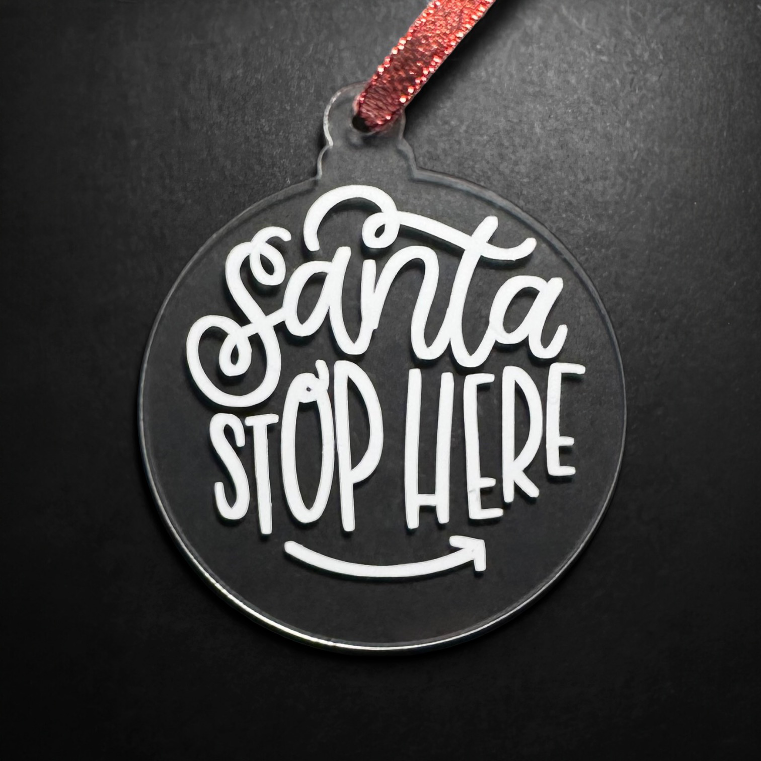 Clear acrylic Christmas ornament with "Santa Stop Here" text.