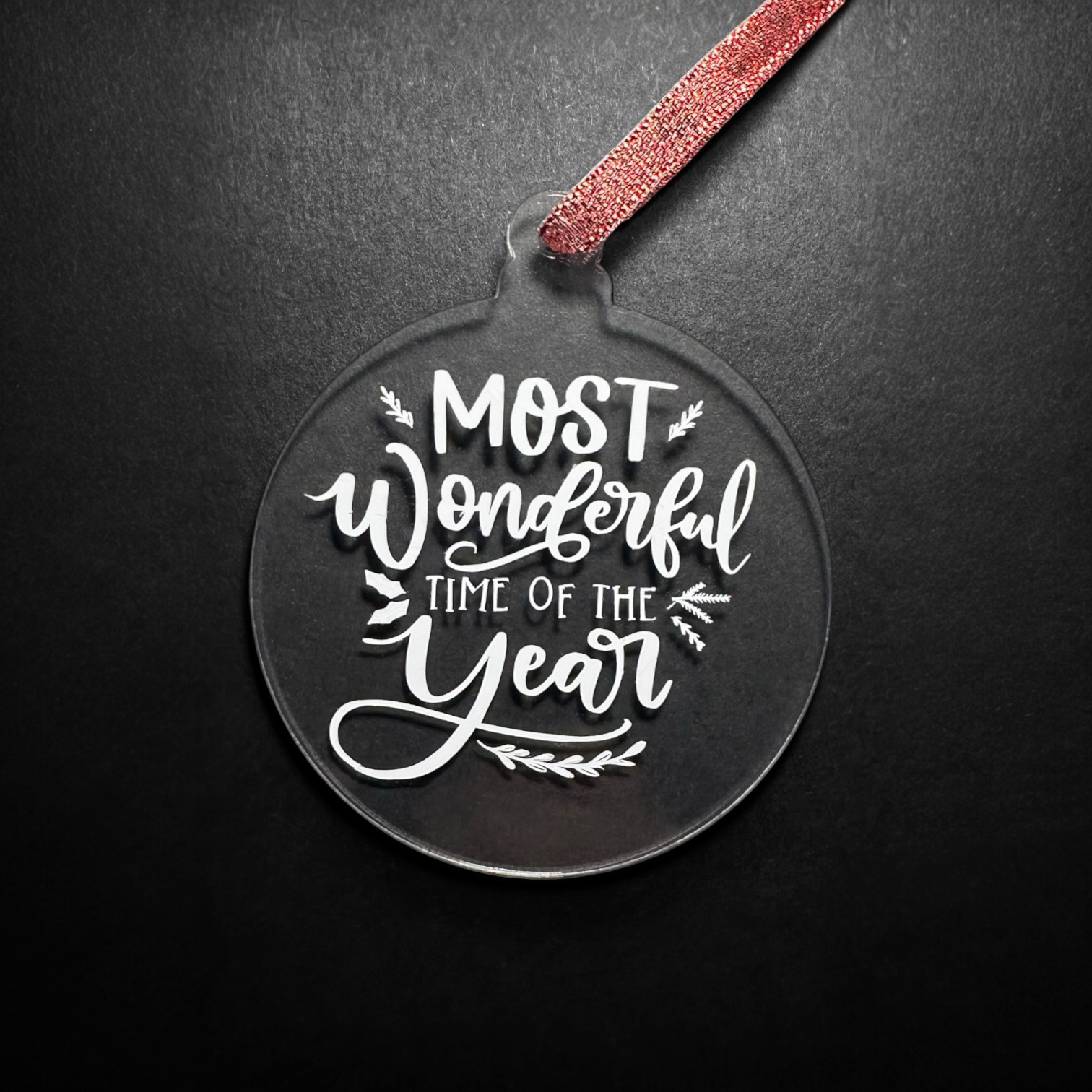 Clear acrylic Christmas ornament with "Most Wonderful Time of the Year" text.