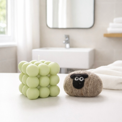 Handmade gift set featuring a light green bubble candle and a brown wool-felted sheep soap.