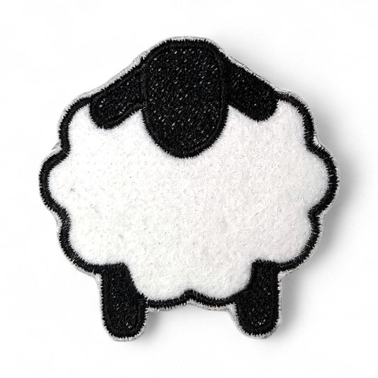 Iron-on embroidered patch of a white sheep with black head and legs.