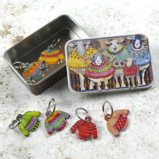 Jumper stitch markers in a tin featuring sheep wearing jumpers.
