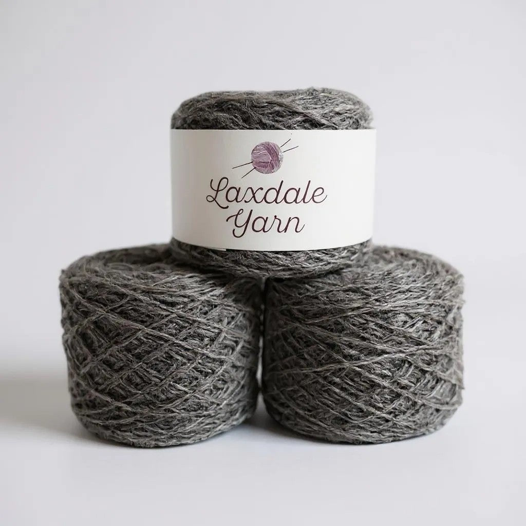 Three spools of Laxdale Yarn in natural light grey wool.