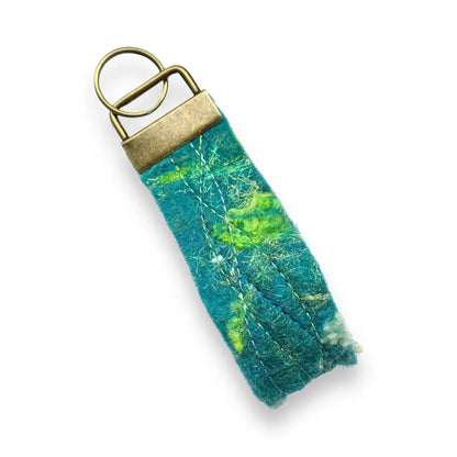 Handmade felt keyring inspired by the Northern Lights in teal and green.