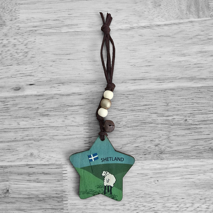 Wooden star ornament with a Shetland flag, sheep, and text.