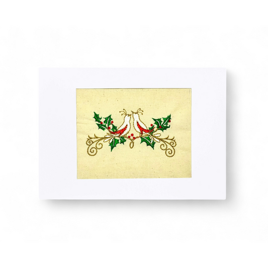 Embroidered turtle doves on a cream background with holly and berries.