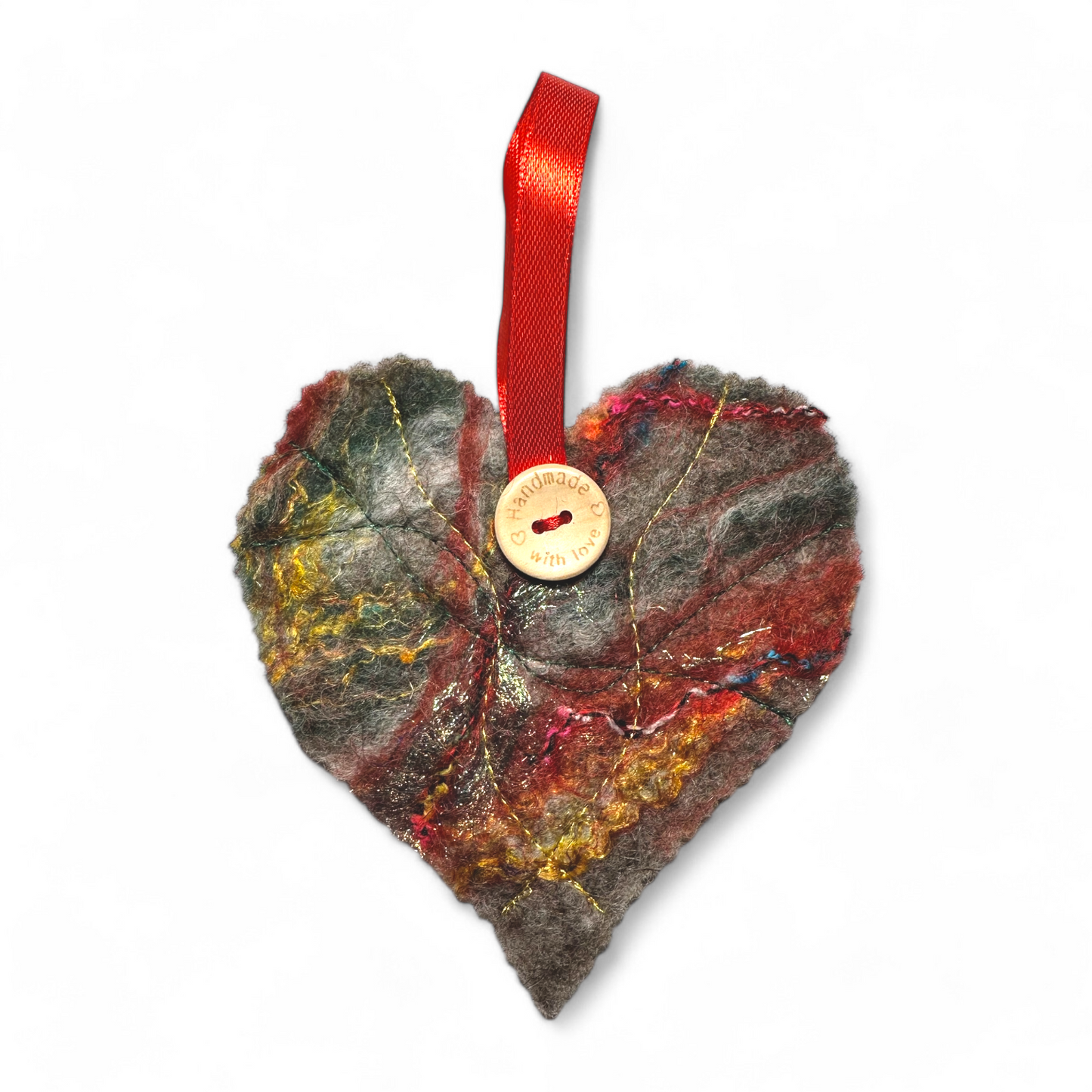 Handmade felt heart Christmas decoration with a red ribbon and wooden button.