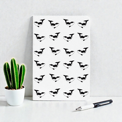 A6 pocket notebook with a pattern of black and white orcas.