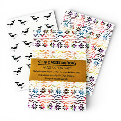 Set of two A6 pocket notebooks featuring rainbow Fair Isle and black and white orca patterns.