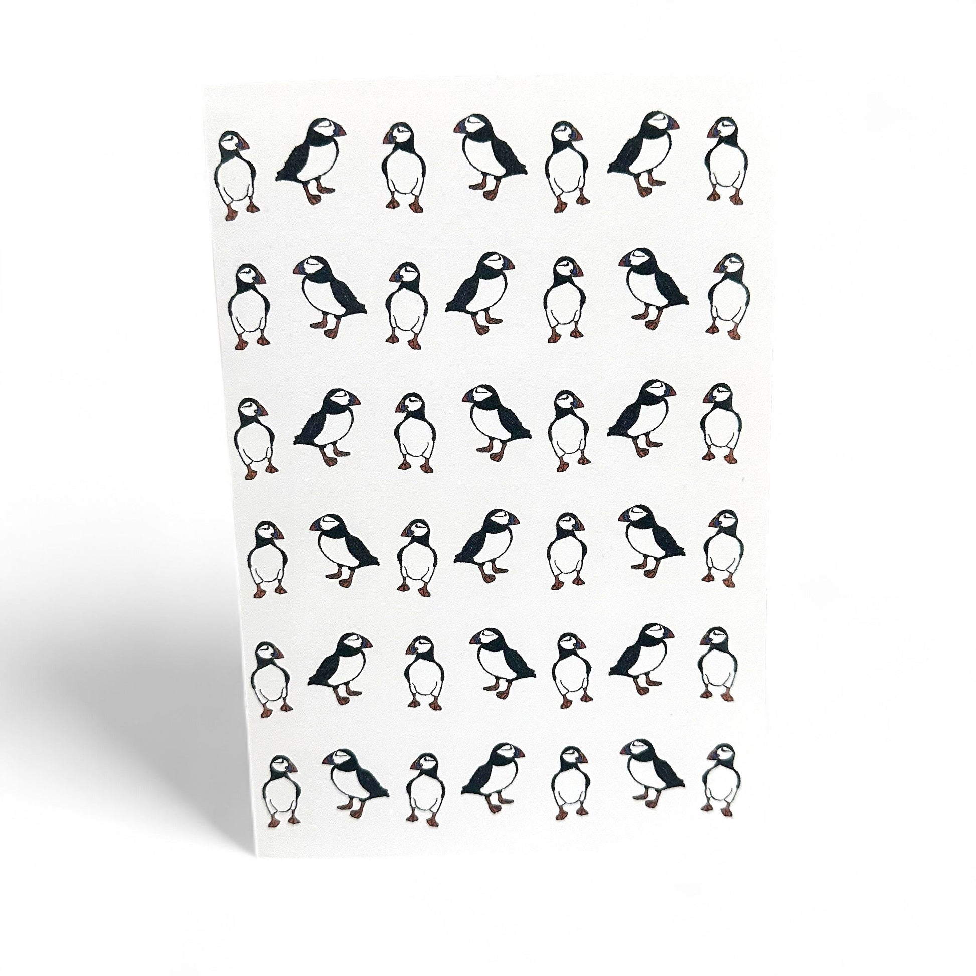 Printed card featuring multiple illustrations of puffins.