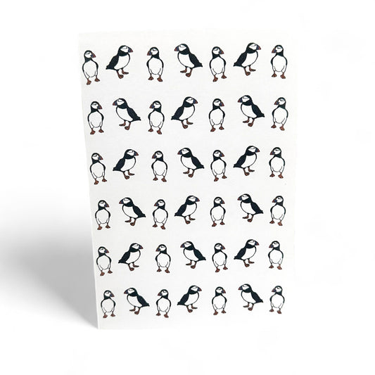 Printed card featuring multiple illustrations of puffins.