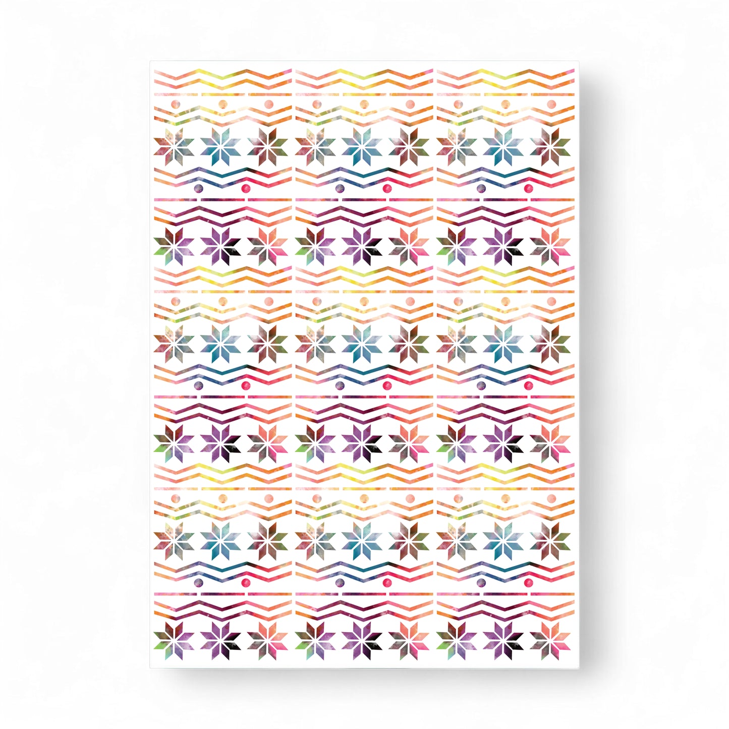 Printed rainbow Fair Isle card with snowflake and zigzag patterns.