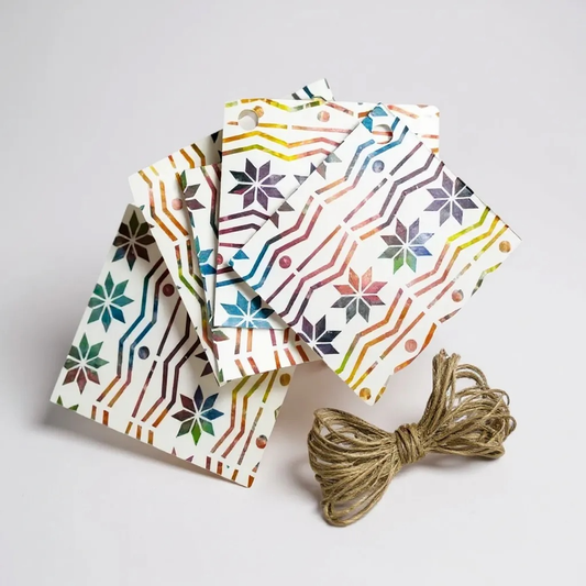 Rainbow Fair Isle gift tags with a colorful geometric pattern and twine.