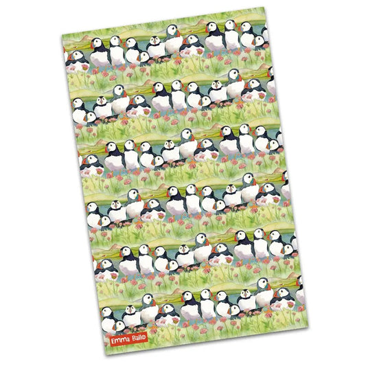 Sea Thrift Puffins tea towel featuring a repeating pattern of puffins and sea thrift flowers.