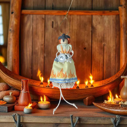 Shetland handmade macramѐ doll with flame-patterned dress and candle accents.