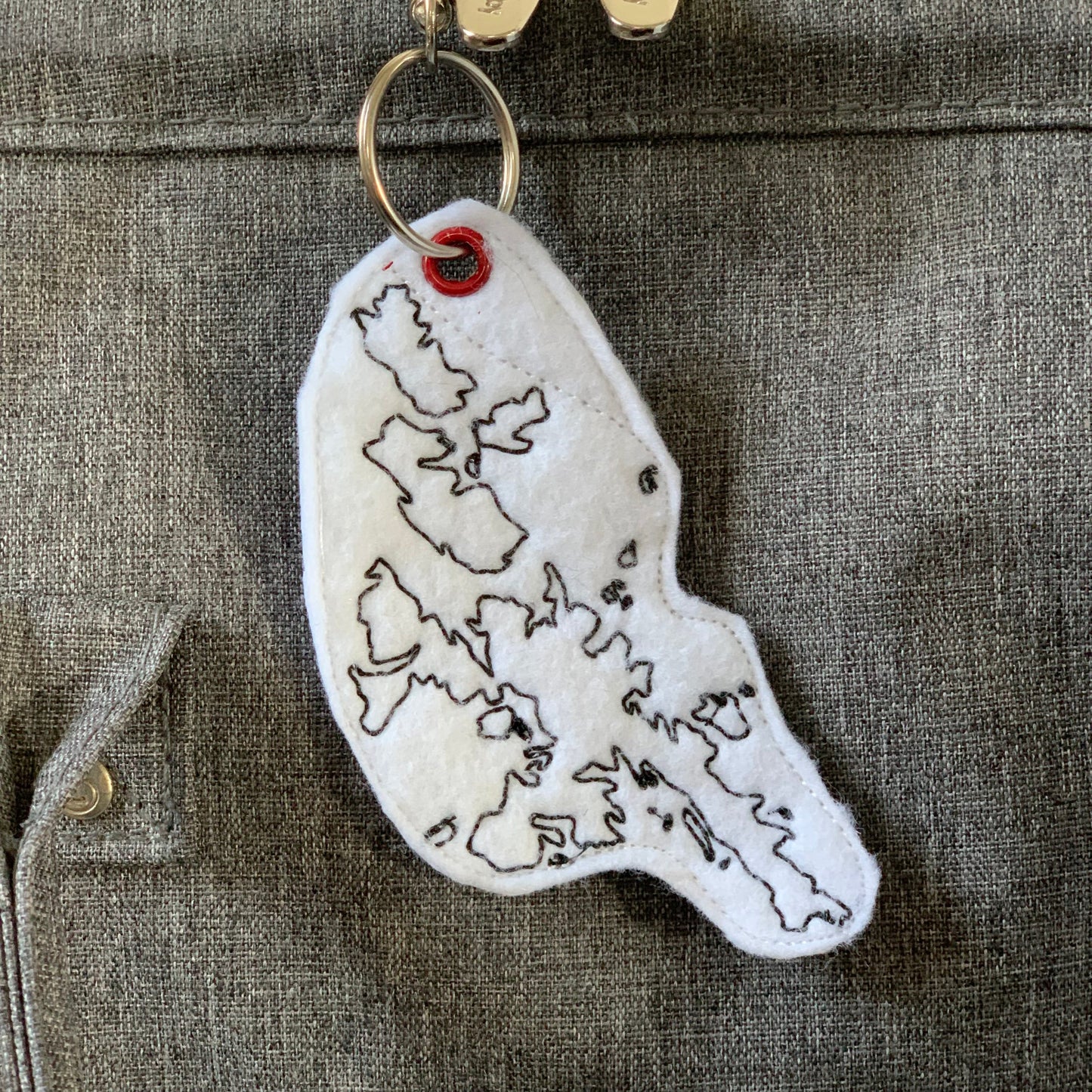 Shetland Isle keyring on grey fabric.