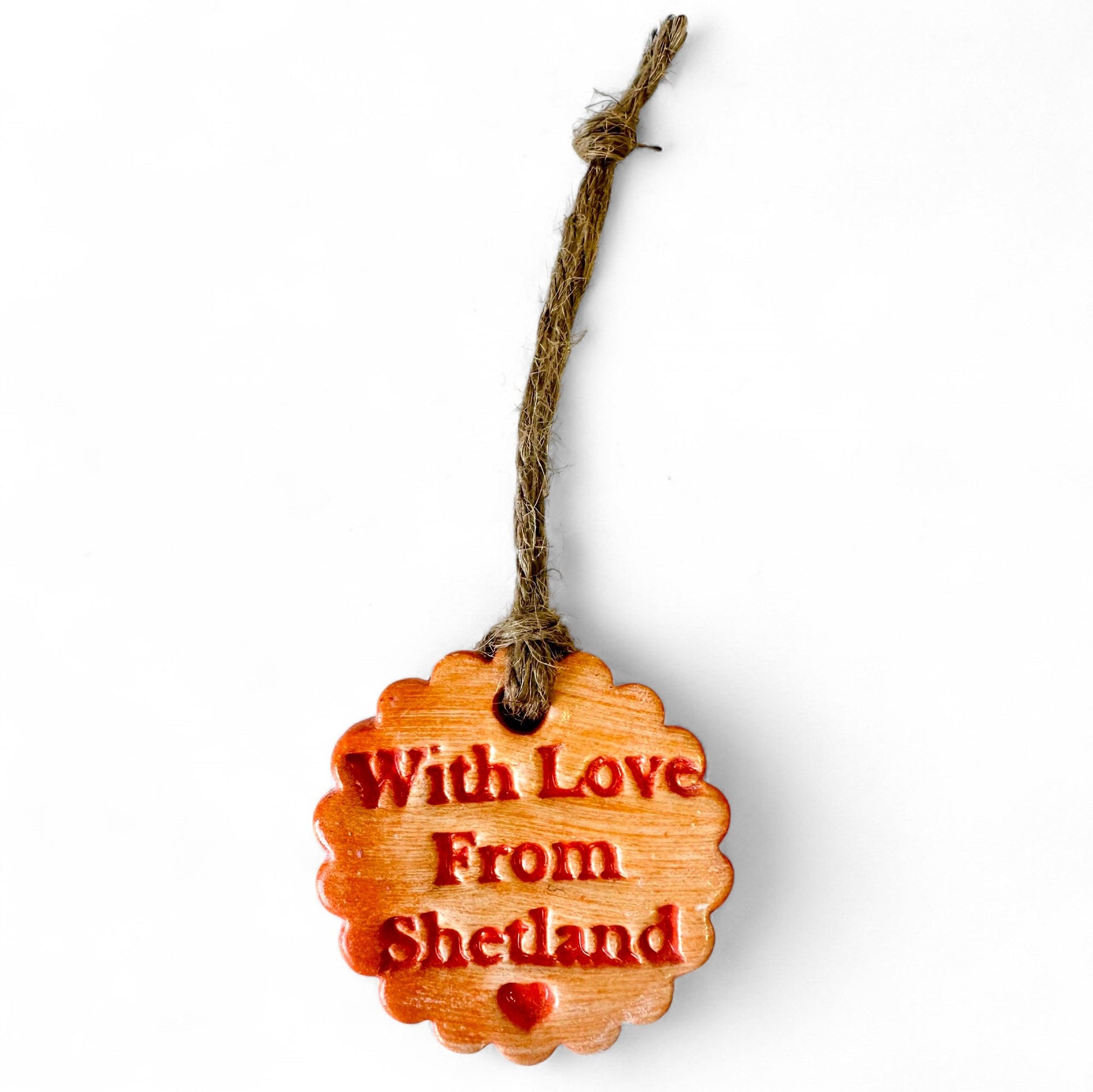 Wooden ornament with "With Love From Shetland" and a heart.