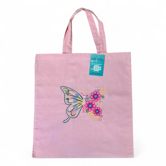 Pink tote bag with an embroidered butterfly and flowers.