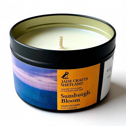 Sumburgh Bloom hand-poured soy candle in a black tin with a coastal landscape label.