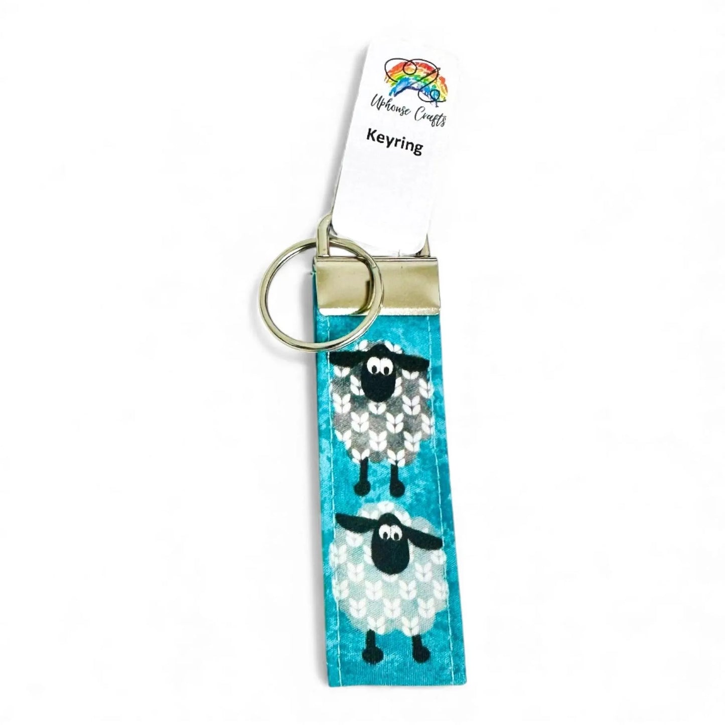 Handmade fabric keyring featuring two illustrated sheep on a teal background with a metal clasp.
