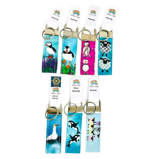 A collection of fabric keyrings featuring colorful Shetland wildlife and coastal designs.